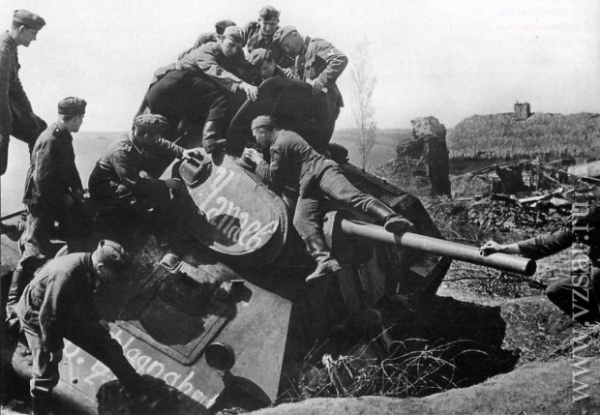 В России с 9 мая поздравили плакатами с нацистами: они осматривают подбитый советский танк